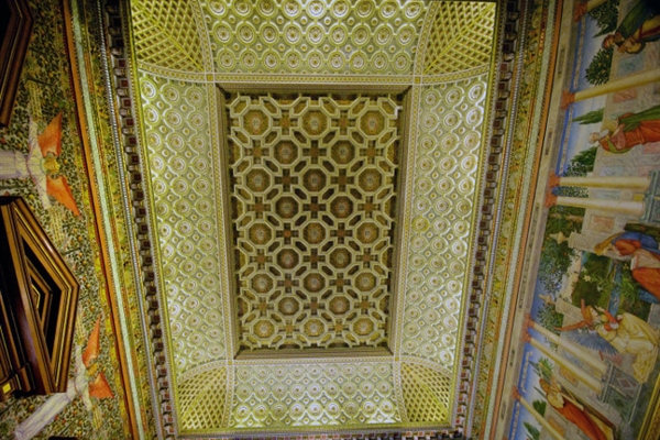 The gilt ceiling, reminiscent of the Royal Chapel in St James' Palace sits above painted frescos.
